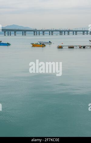 The coastal view of Xiamen, Fujian province, China, with boats and bridge. Stock Photo