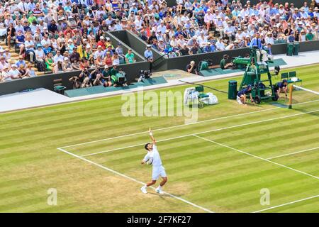 Court No 1 crowds, people watch a match as Novac Djokovic serves, Wimbledon Tennis Championships 2017, All England Lawn Tennis and Croquet Club, UK Stock Photo