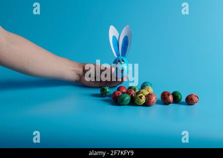 Easter eggs and egg with ears on a blue background Stock Photo