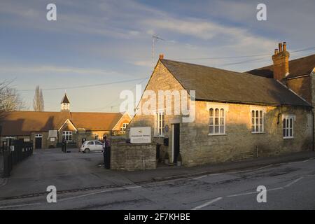 Sharnbrook High Street, Bedfordshire, England, UK, late afternoon - the Victorian buildings of Sharnbrook village primary school Stock Photo