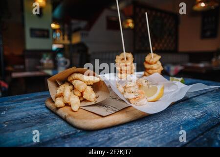 Snacks to beer in batter on a wooden blue background. Stock Photo