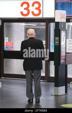 Elderly man waiting for a bus at Preston Bus Station, Lancashire, UK. Stock Photo