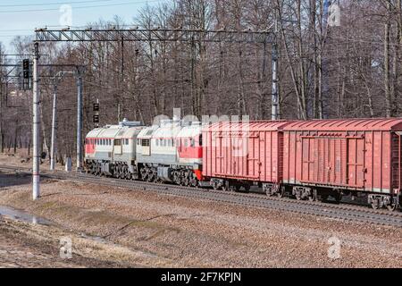 Long freight train approaches to the station. Stock Photo