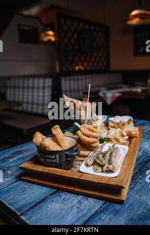 Snacks to beer in batter on a wooden blue background. Stock Photo