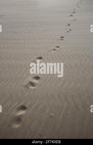 Scotland, Ayrshire, Troon Beach 08 April 2021. Footprints in the beach running diagonally across the photograph frame Stock Photo