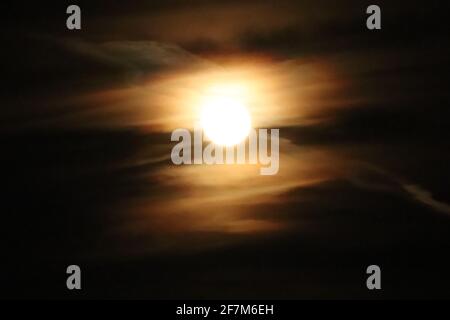 Full moon behind a group of clouds over Nebraska . High quality photo Stock Photo