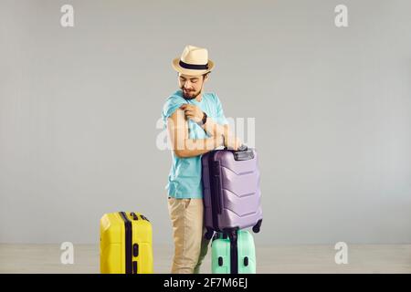 Satisfied vaccinated male tourist going on a long-awaited trip after the coronavirus pandemic. Stock Photo