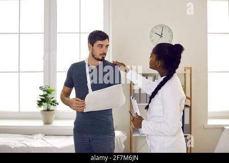 African american doctor conduct medical examination on patient with hand injury Stock Photo