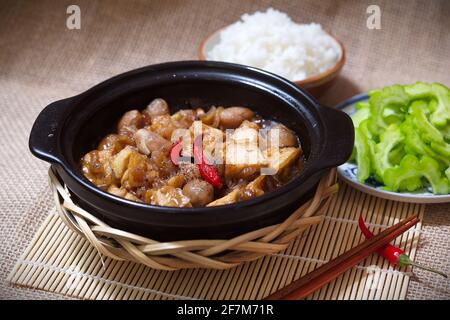 Stewed mushroom and tofu in black pot (Vegan food) with side dishes Stock Photo