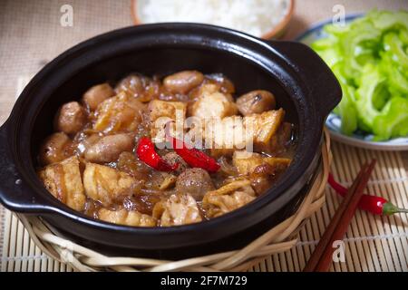 Stewed mushroom and tofu in black pot (Vegan food) with side dishes Stock Photo