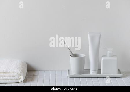 toothbrush, toothpaste, hand soap, folded towel Stock Photo