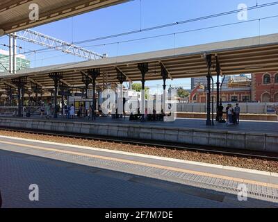 Gdansk, North Poland - August 14, 2020: View of intercity train station and tracks against bunch of passengers waiting to board. Stock Photo