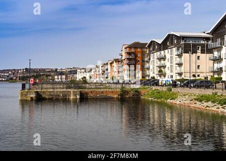 Barry, Wales - March 2021: Flats in apartment buildings on the waterfront in a new housing development around the old docks in Barry Stock Photo
