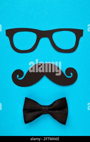 happy father day card, composition with black mustache eyeglasses and bow tie isolated on blue background Stock Photo