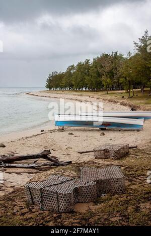 Fishing traps, fishing boats on the beach and the colourful Indian Ocean, Rodrigues Island, Mauritius Stock Photo