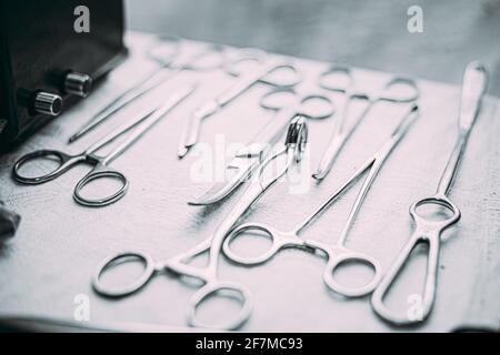 Old Medical And Surgical Instruments. Many Old Surgical Instruments For Surgery. Black And White Toned Shot. Old Different Metal Medical Instruments Stock Photo