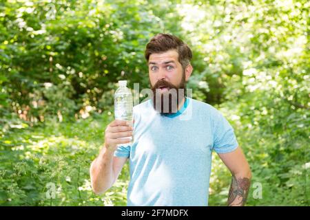 jogging drinking water. guy maintains body water balance. hydration. daily water. Stock Photo