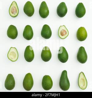 Avocado whole and half on white background. Flat lay, top view. Food concept. Stock Photo