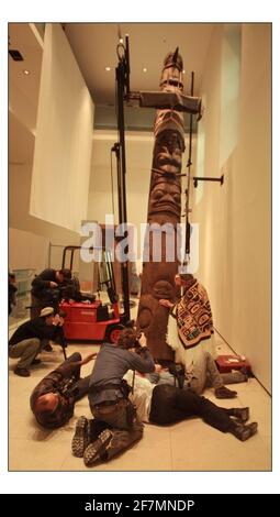 An early and important TOTEM POLE from the Nisga'a Nation, British Colombia raised into position at the British Museum with Chief Gadeelip (literally 'Cheif Anchor') master carver and member of the Nisga'a Eagle-Beaver clan on hand to watch the process. The magnificent 8 meter red cedar pole will be one of the star objects in the forthcoming exhibition LIVING and DYING opening on 3 November.pic David Sandison 17/10/2003 Stock Photo