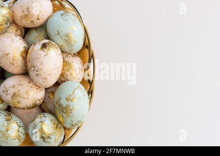 Colorful Easter eggs in basket isolated on white background and copy space on right side Stock Photo