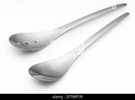 Modern stainless steel metal salad spoons (cutlery for stirring salads, spoon and fork) (kitchen objects collection). Isolated on white background. Stock Photo