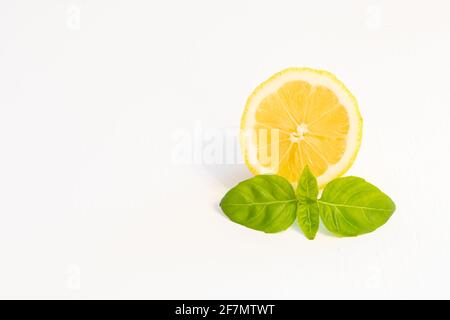 Half yellow lemon fruit isolated on white background with leaf and copy space Stock Photo
