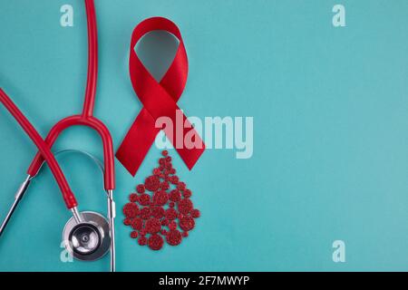 Awareness oncept with blood drop and red ribbon. World Hamophilia day or blood donor day Stock Photo