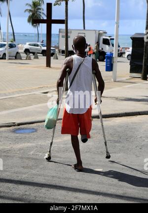 salvador, bahia, brazil - february 4, 2021: man with amputated leg using crutches in the Itapua neighborhood in the city of Salvador. *** Local Captio Stock Photo