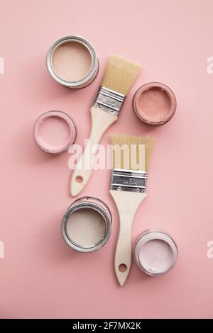 Overhead view of a DIY paint brush with pastel pink sample paint pots Stock Photo