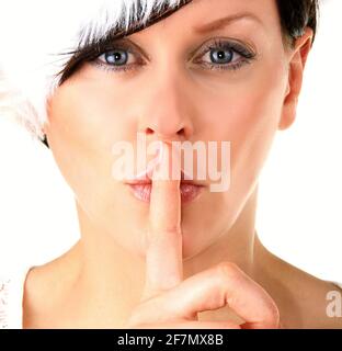 woman with fingers over mouth showing the quiet hand gesture stock photo Stock Photo