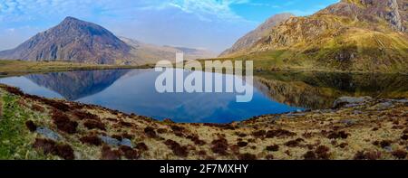 A panorama of Pen yr Ole Wen and Tryfan reflected in Llyn Idwal, Snowdonia National Park in North Wales, UK Stock Photo