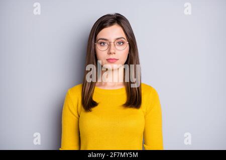 Portrait of attractive calm content girl wearing specs isolated over grey color background Stock Photo