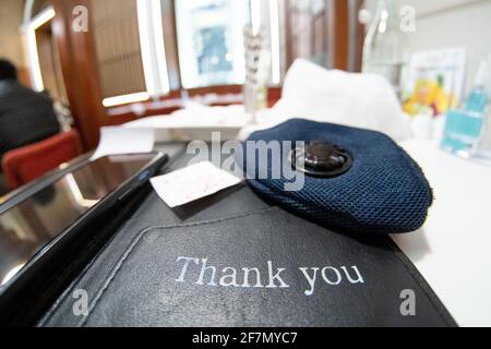 Slow pan up from a card saying thank you and a mask showing small business thanking consumers keeping them safe during the coronavirus pandemic by Stock Photo