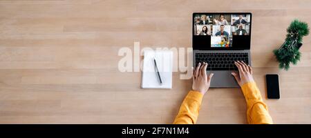 Business briefing, online education, webinar. Top view on laptop screen on the desk with multiracial people gathered together to communicate or learning distantly by video conference. Copy space Stock Photo