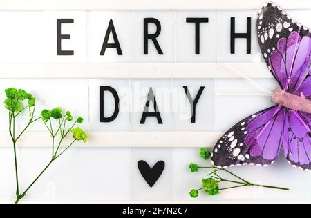 Earth Day text message background, celebration greeting card with lettering, top view Stock Photo