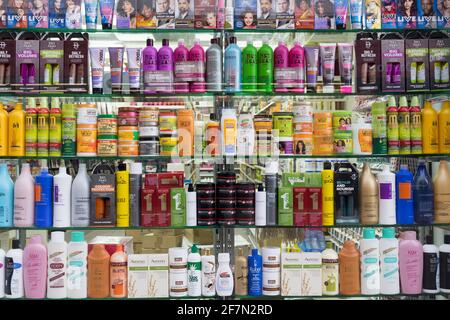 hair care products on display on shelves in haircare shop, barber, hairdresser England UK Stock Photo