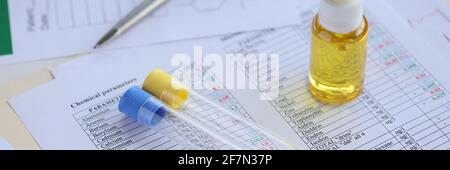 On table are test tubes and oil in bottle. Stock Photo