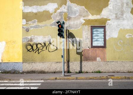 Avenue with artistic wall, colored and conceived as contemporary art, first floor traffic light and window in the urban passage. Stock Photo