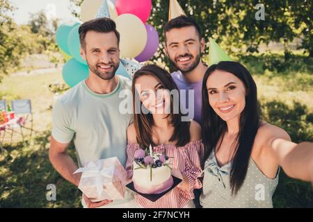 Photo of attractive women and men make selfie camera hold birthday cake present smile outside in outdoors backyard Stock Photo