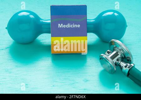 Medicine box and weight for physical exercise symbolizing mental balance Stock Photo