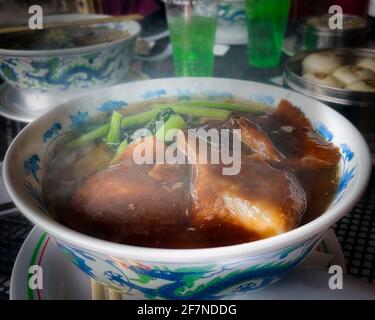 A bowl of hot ramen topped off with pork and greens in Yokohama, Japan. Stock Photo