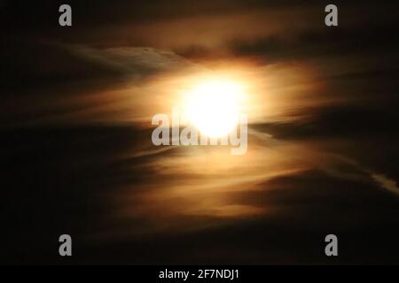 Full moon behind a group of clouds over Nebraska . High quality photo Stock Photo