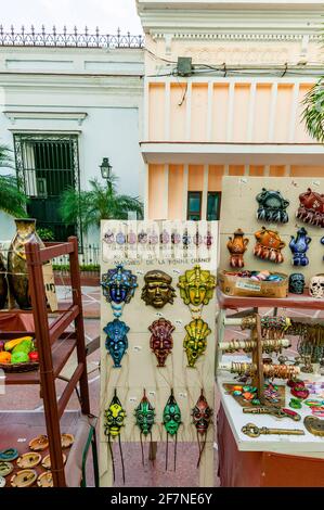Good luck masks and other souvenir tinkets for sale with prices marked in CUCS (Cuban tourist dollars) and sign written in English, French, and Spanis Stock Photo