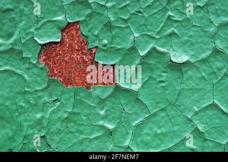 Green cracked enamel paint on rusty wall Stock Photo