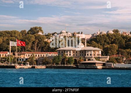 ISTANBUL, TURKEY - 09 07 2020: View from the waters of Bosporus Strait on Basketmakers Kiosk with structures and domes of Topkapi Palace above it Stock Photo