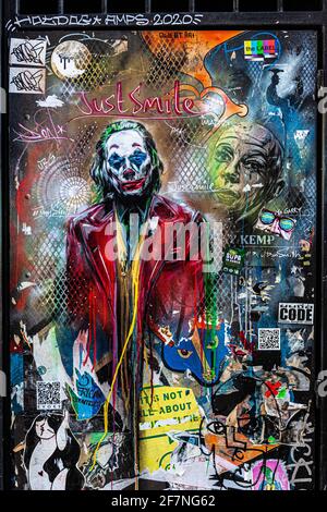 Colourful graffiti of the Joker on a metal door, London, England, UK. Stock Photo