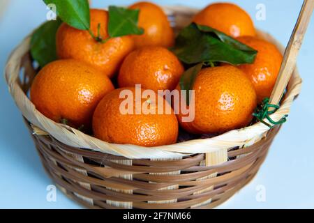 a bowl of oranges on a table Stock Photo
