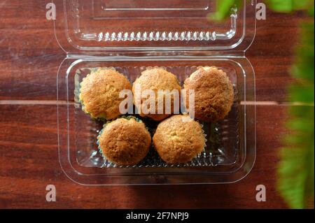 Baked Banana Cake steamed muffin or cupcake on plastic box on wooden table Stock Photo