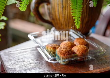 Baked Banana Cake steamed muffin or cupcake on plastic box on wooden table Stock Photo
