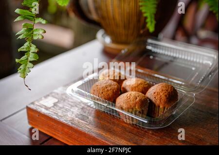 Baked Banana Cake steamed muffin or cupcake on plastic box on wooden table Stock Photo